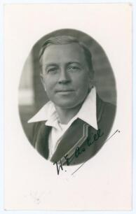 William Ewart Astill. Leicestershire & England 1906-1939. Mono real photograph plain back postcard of Astill in cameo, head and shoulders wearing cricket attire and blazer. Very nicely signed in black ink to the photograph by Astill. Official stamp to ver