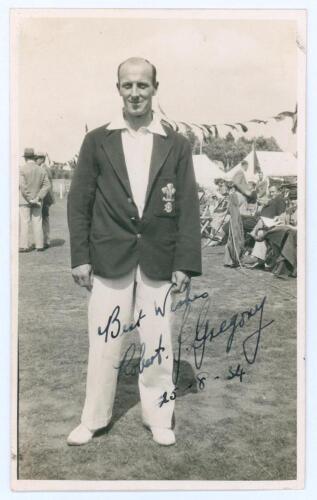 Robert James &lsquo;Bob&rsquo; Gregory. Surrey 1925-1947. Sepia real photograph postcard of Gregory standing full length wearing Surrey blazer, spectators and marquees in the background. Nicely signed in ink to the photograph by Gregory and dated 25th August 1934. Pu