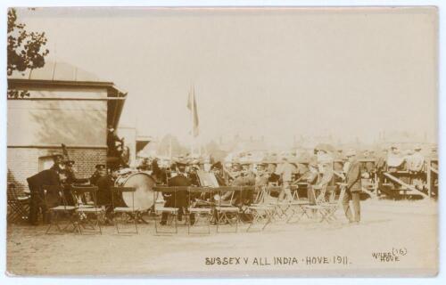 &lsquo;Sussex v India Hove 1911&rsquo;. Rare sepia real photograph postcard for the match played at Hove, 21st- 23rd August 1911. The postcard shows the band playing to entertain the crowds. Wiles of Hove, no. 16. Postally unused. Light creasing, some tape and adhesi