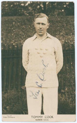 Thomas Edwin Reed &lsquo;Tommy&rsquo; Cook. Sussex 1922-1937. Sepia real photograph plain back postcard of Cook standing three quarter length wearing cricket attire and Sussex sweater. Printed title &lsquo;Tommy Cook, Sussex C.C.C.&rsquo;. Signed in ink to photograph by Cook. Pu