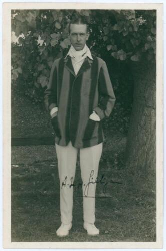 Alfred Herbert Harold Gilligan. Sussex & England 1919-1931. Mono real photograph postcard of Gilligan standing full length wearing cricket attire and blazer. Nicely signed in ink to the photograph by Gilligan. Official stamps to verso for Nias and A.G. Sp