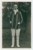 Alfred Herbert Harold Gilligan. Sussex & England 1919-1931. Mono real photograph postcard of Gilligan standing full length wearing cricket attire and blazer. Nicely signed in ink to the photograph by Gilligan. Official stamps to verso for Nias and A.G. Sp