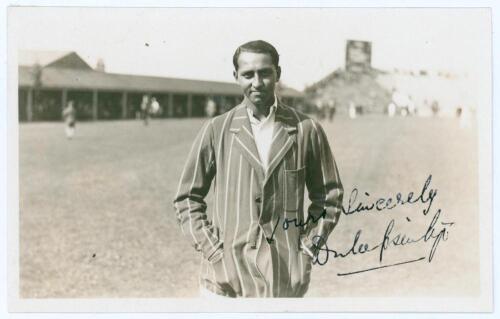 Kumar Shri Duleepsinhji. Sussex, Cambridge University & England 1924-1932. Original sepia real photograph plain back postcard of Duleep standing three quarter length at Scarborough, wearing striped blazer. Nicely signed in black ink to the photograph by D
