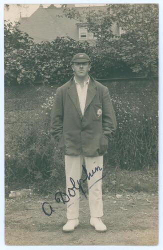 Arthur Dolphin. Yorkshire, Patiala & England 1905-1927. Sepia real photograph postcard of Dolphin standing full length wearing cricket attire and Yorkshire cap and blazer. Nicely signed in ink to the photograph by Dolphin. Official stamps to verso for Nia