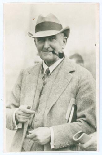 Charles Burgess Fry. Sussex, Hampshire, Oxford University, Europeans & England 1892-1922. Mono real photograph plain back postcard of Fry depicted in later years, half length wearing a suit and trilby hat and smoking a pipe. Annotation in ink to verso des