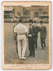 Charles Burgess Fry and Lord Hawke. M.C.C. v Rest of England 1914. Original sepia photograph of C.B. Fry wearing cricket attire, standing with his back to the camera, and Lord Hawke, partially obscured by Fry, in conversation with King George V on the out