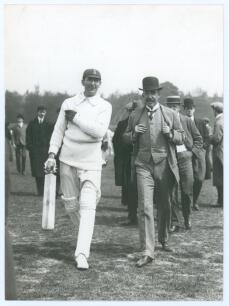 Charles Burgess Fry. Sussex, Hampshire, Oxford University, Europeans & England 1892-1922. Mono press photograph of C.B. Fry walking off the field of play wearing batting attire and England cap. Walking alongside him is Prince Albert of Schleswig Holstein 