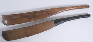 Replica early cricket bats. Two full size replica wooden cricket bats with sloping shoulders, made to represent bats from the 1700s. One with black stringed handle. Good condition.
