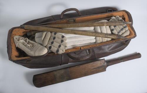 Leather cricket bag and kit. An early leather cricket bag containing a full size bat by Cobbett of Marylebone with serial number D.50291 stamped to rear splice. A pair of &lsquo;Tony Lock Junior&rsquo; size 8 canvas cricket boots, hardly used. Also two pairs of batti