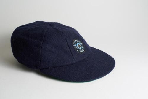 Indian navy blue cloth Test cap, by Ad-Art of Bombay, with wired emblem of India with wording &lsquo;Indian Cricket Team&rsquo;. Appears match worn, good condition. Ownership unknown.