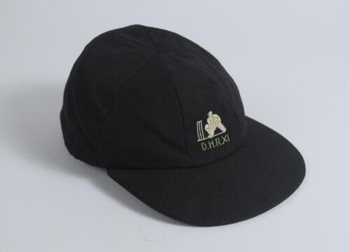 Derrick Robins XI navy blue cloth cricket cap, by Michael of Chatham, with embroidered emblem with &lsquo;D.H.R. XI&rsquo; below to front. Appears match worn, good condition. Ownership unknown.