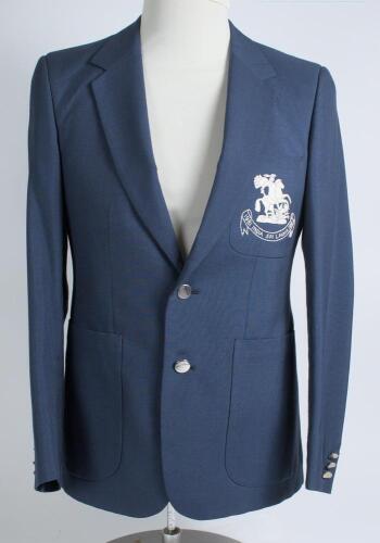 Robert William &lsquo;Bob&rsquo; Taylor. Derbyshire & England 1961-1988. M.C.C. mid blue touring blazer, by Burton, worn by Taylor on the M.C.C. tour of India and Sri Lanka in 1981/82. The blazer with embroidered M.C.C. emblem in white of St George & Dragon of Englan