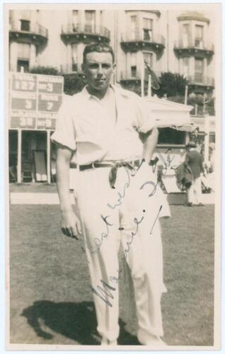 Maurice William Tate. Sussex & England 1912-1937. Sepia real photograph postcard of Tate standing full length wearing cricket attire on the outfield at Hastings. Signed in black ink to the photograph by Tate. Publisher unknown. Postally unused. Very good 