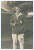 Maurice William Tate. Sussex & England 1912-1937. Excellent mono real photograph postcard of Tate standing three quarter length wearing M.C.C. blazer and holding pipe. Very nicely signed in ink to the photograph by Tate. Official stamps to verso for Nias 