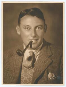 Maurice William Tate. Sussex & England 1912-1937. Excellent original sepia studio portrait photograph of Tate, head and shoulders wearing a suit and tie, pipe in his mouth. The photograph, with blind embossed stamp for Monte Luke Studio, 101 The Strand, S