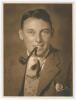 Maurice William Tate. Sussex & England 1912-1937. Excellent original sepia studio portrait photograph of Tate, head and shoulders wearing a suit and tie, pipe in his mouth. The photograph, with blind embossed stamp for Monte Luke Studio, 101 The Strand, S