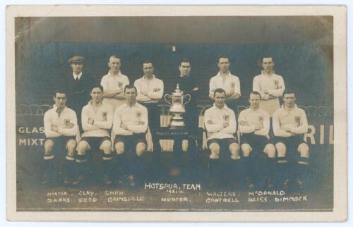 Tottenham Hotspur Cup Team 1921-22. &lsquo;Hotspur Team&rsquo;. Early mono real photograph postcard of the team and trainer, Minter, standing and seated in rows on the pitch with printed title and players names printed beneath, to lower border. Appears to be W.J. Cra