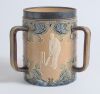 Doulton Lambeth stoneware tyg. Large, than normal, and impressive three handled tyg with three moulded relief vignettes of cricketers, a batsman, a fielder and wicket keeper in white on a brown background with stylised floral leaf and flower Art Nouveau d
