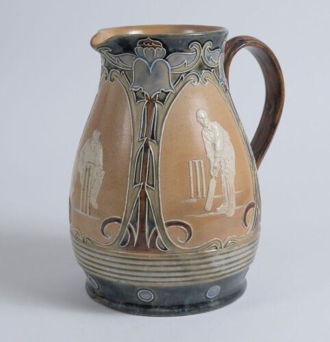 Cricketing jug. A large and impressive Doulton Lambeth stoneware jug, of bulbous form, with three moulded relief vignettes of cricketers, a batsman, bowler and wicket keeper, Abel, Woods and McGregor in white on a brown background. With stylised floral le