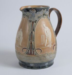 Cricketing jug. A large and impressive Doulton Lambeth stoneware jug, of bulbous form, with three moulded relief vignettes of cricketers, a batsman, bowler and wicket keeper, Abel, Woods and McGregor in white on a brown background. With stylised floral le