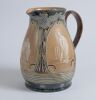 Cricketing jug. A large and impressive Doulton Lambeth stoneware jug, of bulbous form, with three moulded relief vignettes of cricketers, a batsman, bowler and wicket keeper, Abel, Woods and McGregor in white on a brown background. With stylised floral le