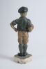 &lsquo;The Captain&rsquo;. Early plaster figure of a boy in football attire holding a brown football to side with hand on his hip. The boy is wearing a green jersey, yellow shorts, green socks and green cap. &lsquo;Captain&rsquo; inscribed to the chest of the boy&rsquo;s jersey. To ba - 2