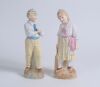 &lsquo;Young England and Young England&rsquo;s sister&rsquo;. A nice pair of continental bisque figures of a boy, wearing cream and blue hooped cap holding a cricket ball and a young girl, wearing a cream and pink hooped cap, dressed in three-quarter dress holding a cricke