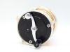 A fine and rare S.E. Bogdan model 150 multiplying salmon fly reel, black/champagne anodised right hand wind model with serpentine crank handle set within an anti-foul rim, block foot, stamped model details, rear milled optional check button and off-set t