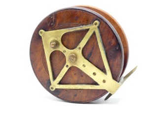 A Nottingham 7" walnut "diamond" back sea centre pin reel, brass backed drum with twin turned wooden handles on brass plates, recessed spindle well with wing locking nut, brass foot with diamond support stancheon and sliding optional check button, circa 1