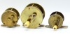 A 19th Century 2 &frac34;" brass multiplying winch, turned bone handle on off-set curved crank winding arm, rivetted block foot, triple pillared cage, no check, circa 1850, a similar 1 &frac34;" multiplying winch, foot pierced to take leather pad, circa 1850 and anothe