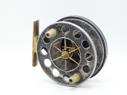 An Allcock Aerial 7950-T10 4" centre pin reel, caged and six spoked drum with twin stepped xylonite handles, ventilated front flange (eight holes) and twin release/regulator forks, brass stancheon foot, rim mounted optional check lever and bar spring che