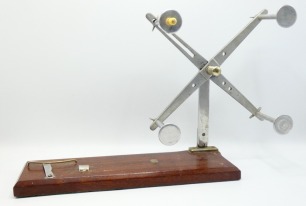 A Hardy Practical line drier, chamfered rectangular mahogany base, bulbous ivorine winding handle, four adjustable alloy arms on folding support and nickel silver thumb screw locking bracket, base with alloy Universal winch fitting and applied oval nicke