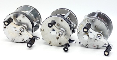 A scarce Record 2000 wide drummed bait casting reel, twin handled crank winding arm above a milled disc tension adjuster, level-line mechanism, rim pressure brake button, rear optional check button, a similar Record 1900 bait casting reel and a Record Sp