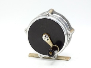 A Julius Vom Hofe model 44 raised pillar trout fly reel, hard rubber side plates, ebonite handle on short crank winding arm, triple raised nickel silver pillars, bridge foot, fixed click check mechanism, only light signs of use, 1960's (see illustration)