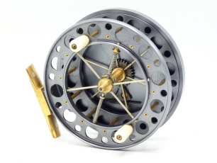 A Garry Mills Perfection Classic T7 4 &frac12;" prototype centre pin reel, graphite anodised finish, caged and six spoked drum with twin ivorine handles, double ventilated flanges and twin release/regulator forks, brass stancheon foot, rear sliding optional che