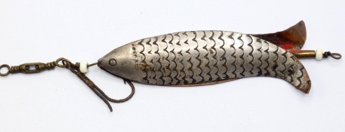 A scarce Victorian 3" white metal bait, the fish shaped split tailed lure constructed of two thin nickel silvered panels each with incised scale decoration, central revolving swivel with glass bead stops, barrel swivel and single head hook (tail hook lac