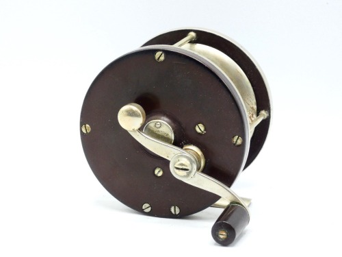 An Edward Vom Hofe Pasque 4/0 multiplier tarpon reel, ebonite and nickel silver construction with off-set serpentine crank handle, 2.5:1 ratio gearing, pierced off-set foot, triple cage pillars, auxiliary leather brake pad, rear sliding optional check dis