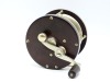 An Edward Vom Hofe Pasque 4/0 multiplier tarpon reel, ebonite and nickel silver construction with off-set serpentine crank handle, 2.5:1 ratio gearing, pierced off-set foot, triple cage pillars, auxiliary leather brake pad, rear sliding optional check dis