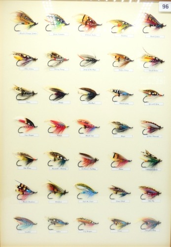 A framed display of thirty five fully dressed salmon flies tied by Barry Grewcock of Brora, tied to 3/0 and 4/0 irons, various patterns each with printed name plaque and mounted on cream card backboard, framed and glazed, 25 &frac14;" x 18 &frac12;" overall, Barry Grew
