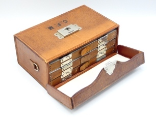 A good Wheatley made rectangular leather salmon fly reservoir, interior fitted three slide out double sided alloy fly trays, each fitted nickel silver spring clips and leather tabs holding a small selection of various flies including some in Hardy packets