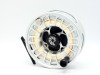 A Nautilus NV Eleven Twelve salmon fly reel, large arboured skeletal drum with counter-balanced handle and milled locking cap, blue anodised block foot and rear spindle mounted tension adjuster, only very light use, in neoprene pouch and card box (see ill