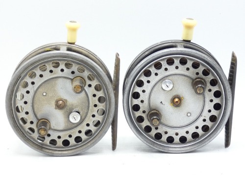 A pair of Hardy Silex Major 3 &frac34;" bait casting reels, each with shallow cored drum, twin ebonite handles, spring drum latch, ribbed brass foot, ivorine handled rim casting trigger, milled rim tension regulator and rear ivorine quadrant weight indicator, on