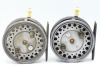 A pair of Hardy Silex Major 3 &frac34;" bait casting reels, each with shallow cored drum, twin ebonite handles, spring drum latch, ribbed brass foot, ivorine handled rim casting trigger, milled rim tension regulator and rear ivorine quadrant weight indicator, on