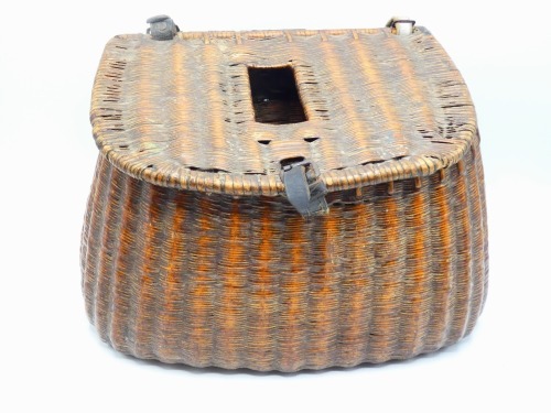A French reed trout fisher's creel of flared form, slopping lid with rectangular fish hole and leather strap hinges and lock, canvas shoulder strap, 14" wide, circa 1920 and another continental wicker trout fisher's creel of similar form, un-varnished fin