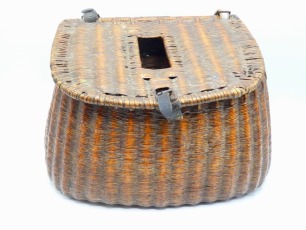 A French reed trout fisher's creel of flared form, slopping lid with rectangular fish hole and leather strap hinges and lock, canvas shoulder strap, 14" wide, circa 1920 and another continental wicker trout fisher's creel of similar form, un-varnished fin