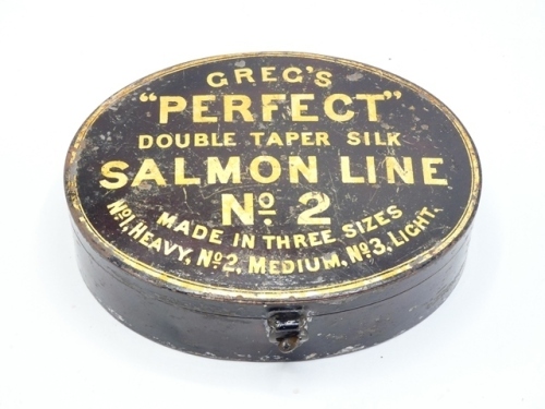 A scarce Greg's "Perfect" Salmon Line No.2 japanned tin box, oval case with hinged cover, turn-key hasp latch, gilt painted line details, interior lacking central fly holder, 6" wide, circa 1890 (see illustration)