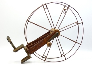 An early Chas. Farlow "cartwheel" line drier, the 12" diameter iron wire wheel line retainer with wooden arbour, applied brass oval trade plaque and mounted on iron ogee shaped support with brass "G" clamp table fitment and turned wooden winding knob o