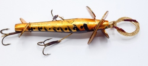 A Foster's Perfect K.D. Devon 3" bait, the hollow split metal tapered body with gilt/brown painted trout pattern, large twin turbine head spinning vanes and rear twin tail vanes, one head vane stamped "patent", two side and one gut mounted flying treble h