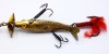 A rare Gregory Acme 3" gilt metal spinning bait, the hollow fish shaped lure with incised scale decoration, slightly curved tail, twin amber and black spot glass eyes, four blade turbine head spinning vanes, hollow spindle shaft with rear treble hook, two