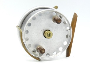 A scarce Hardy Longstone 3 &frac12;" sea centre pin reel, drum with single band of perforations, twin ebonite handles and milled nickel silver spindle tension nut, brass foot, Bickerdyke line guide, rim mounted optional check lever, backplate stamped make and m